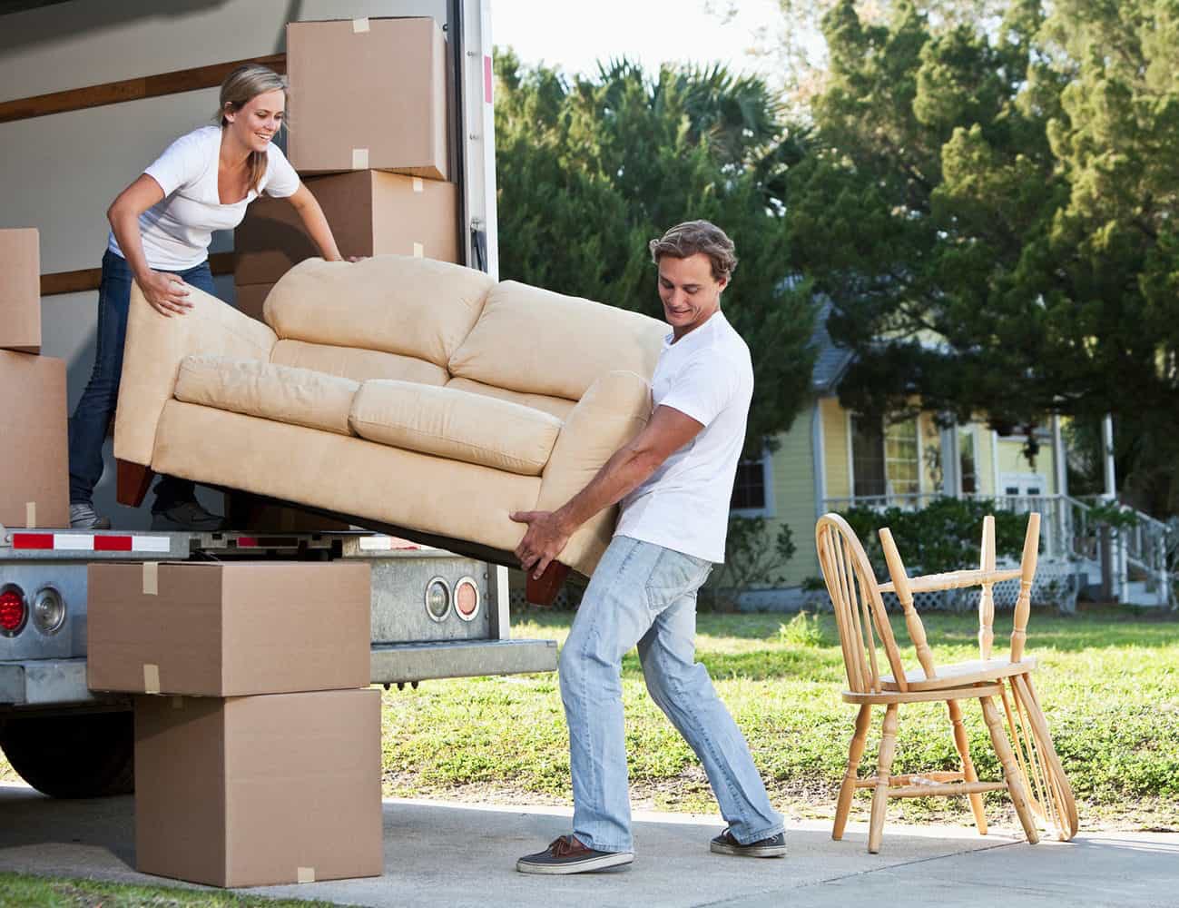 Couple loading a couch on moving truck
