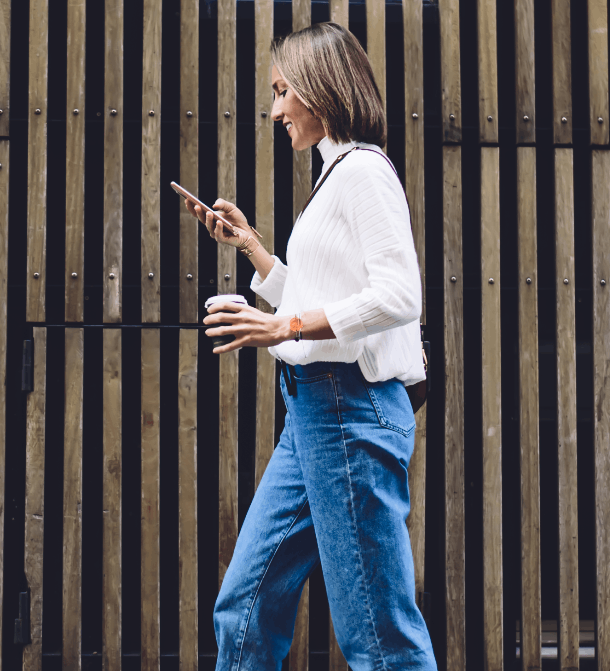 woman walking and texting outside