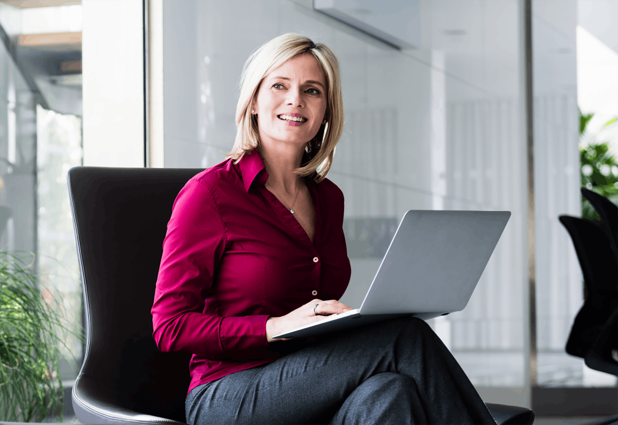 Woman in office sitting using laptop