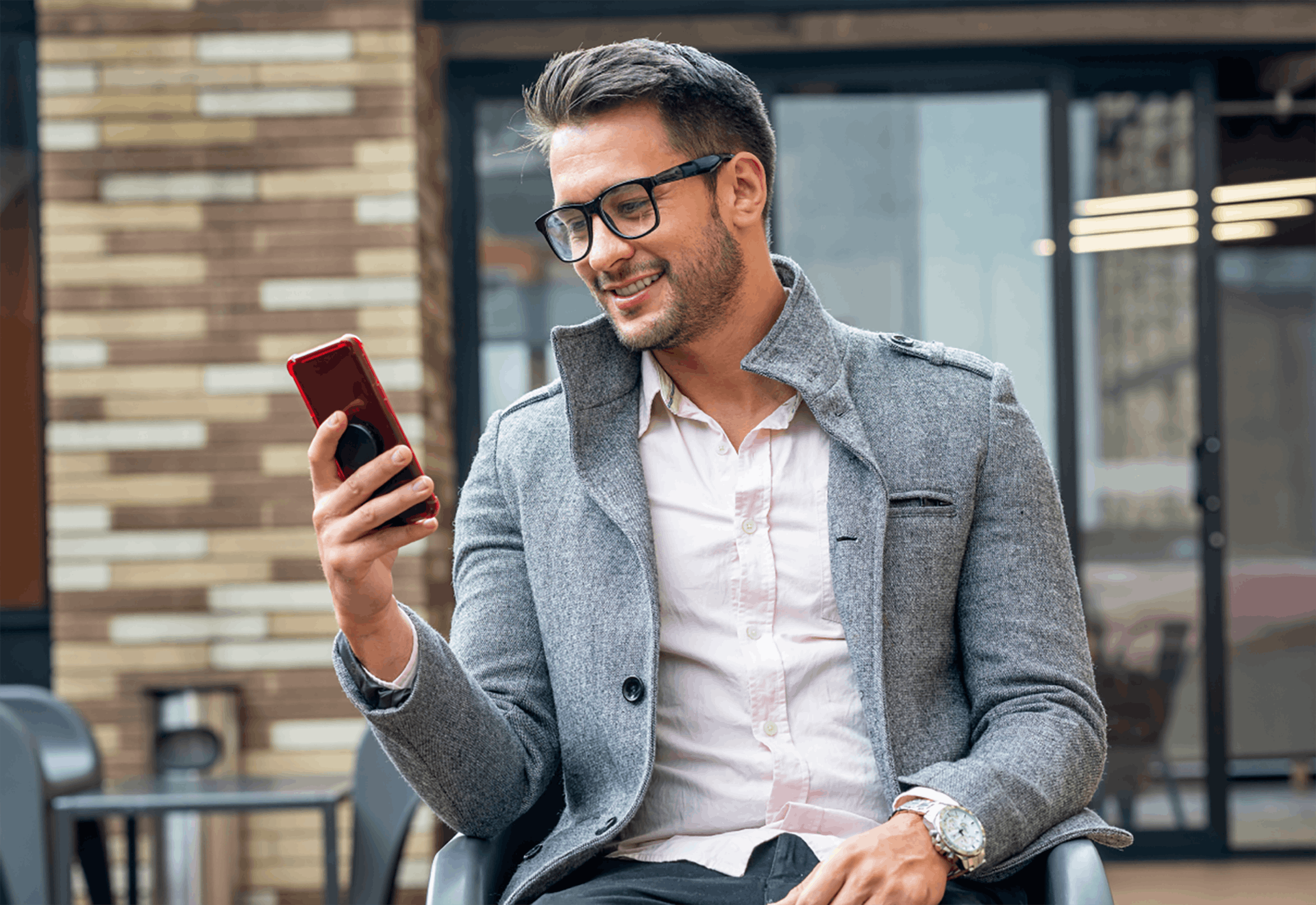 man smiling and using phone