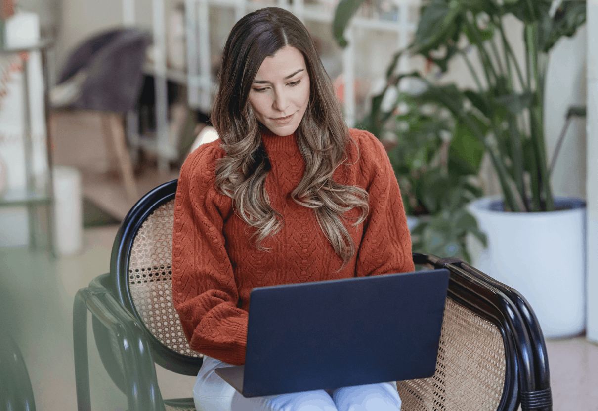 Woman sitting in chair on laptop