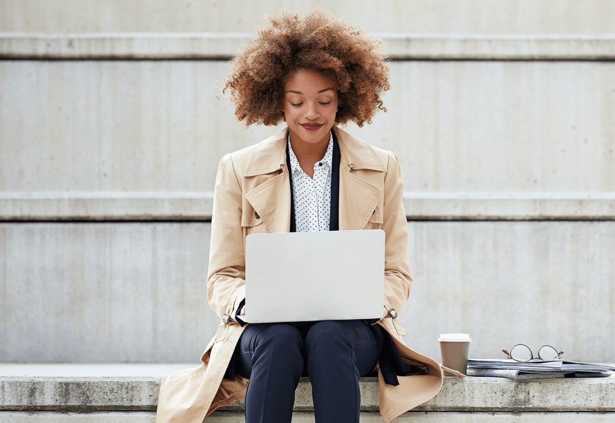 Woman sitting outside on laptop