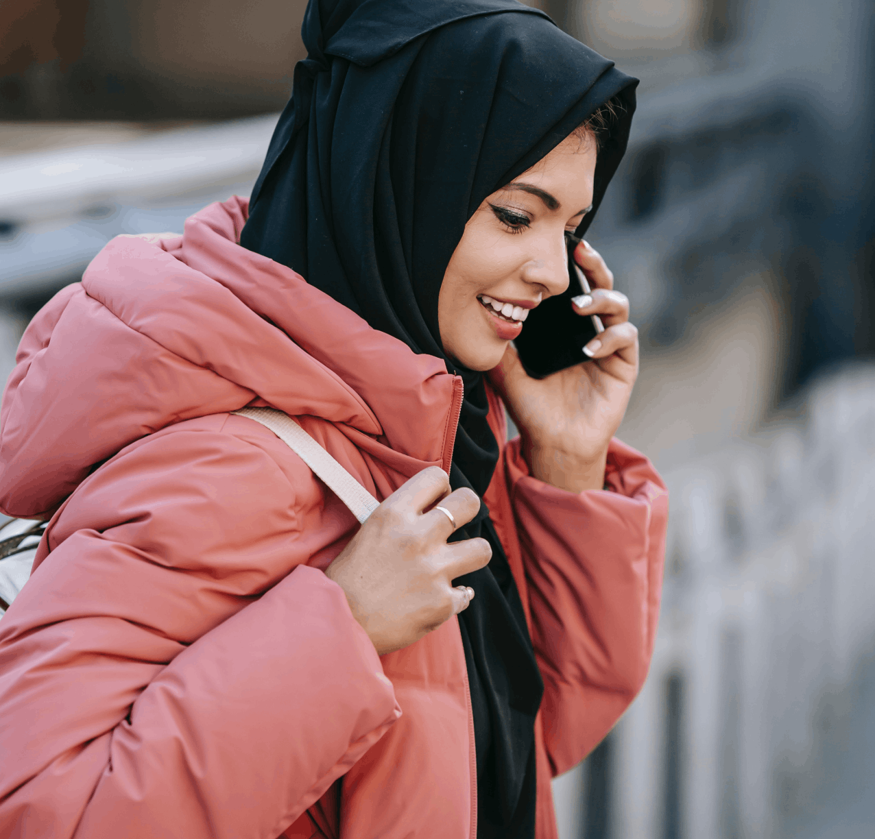 woman wearing coat talking on the phone outside